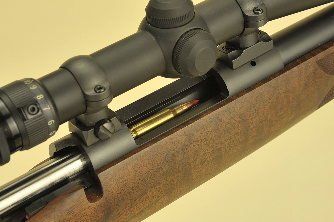 Since Stan’s gun is a single shot, just laying a cartridge into the receiver and pushing it forward into the chamber, makes the rifle ready for action. Crisp detailing of the inletting is evident around the action and bolt handle notch. Leupold rings match the Redfield scope and the rifle is right on the money.